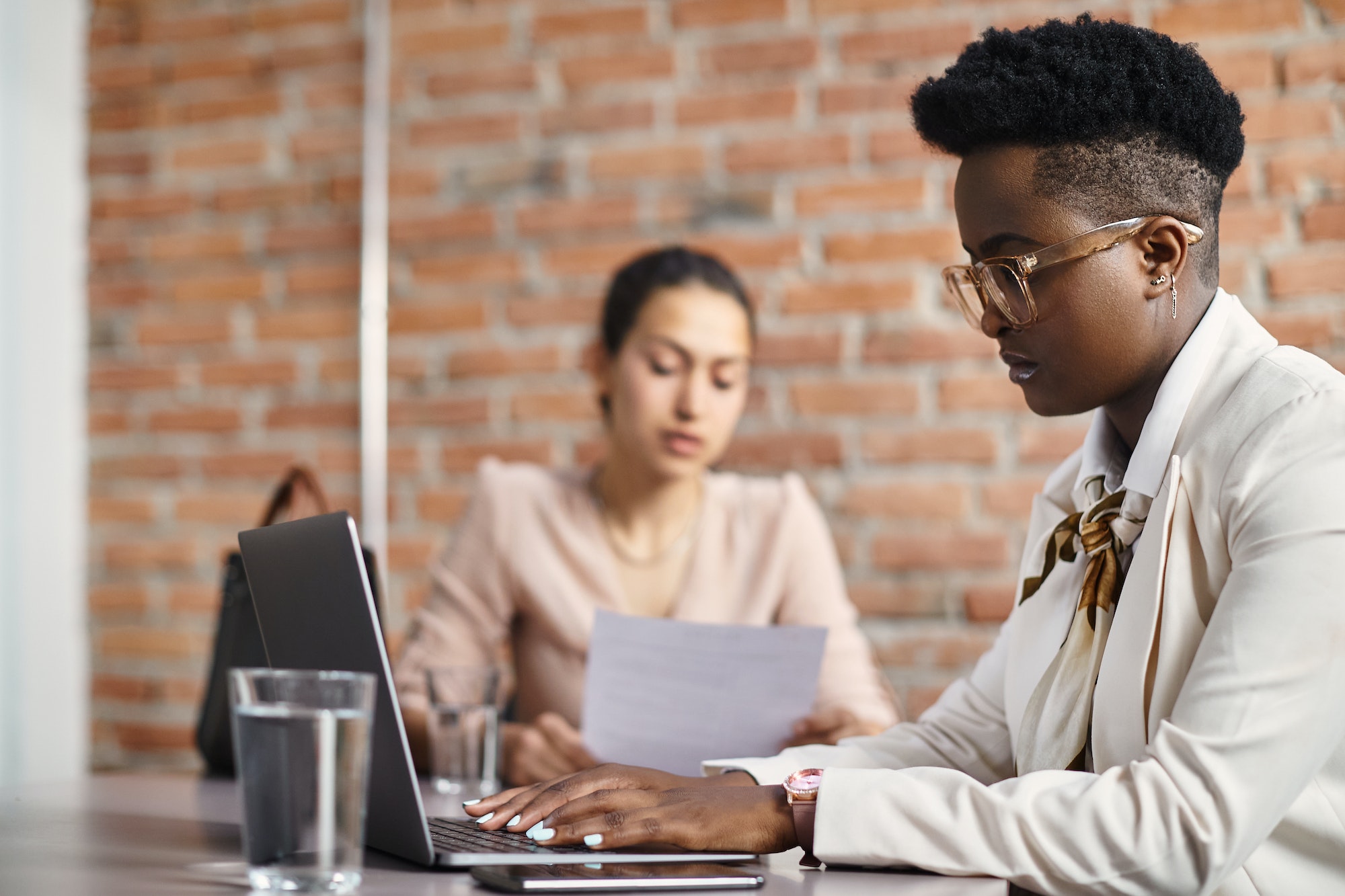 African American businesswoman working on laptop during job interview in the office.