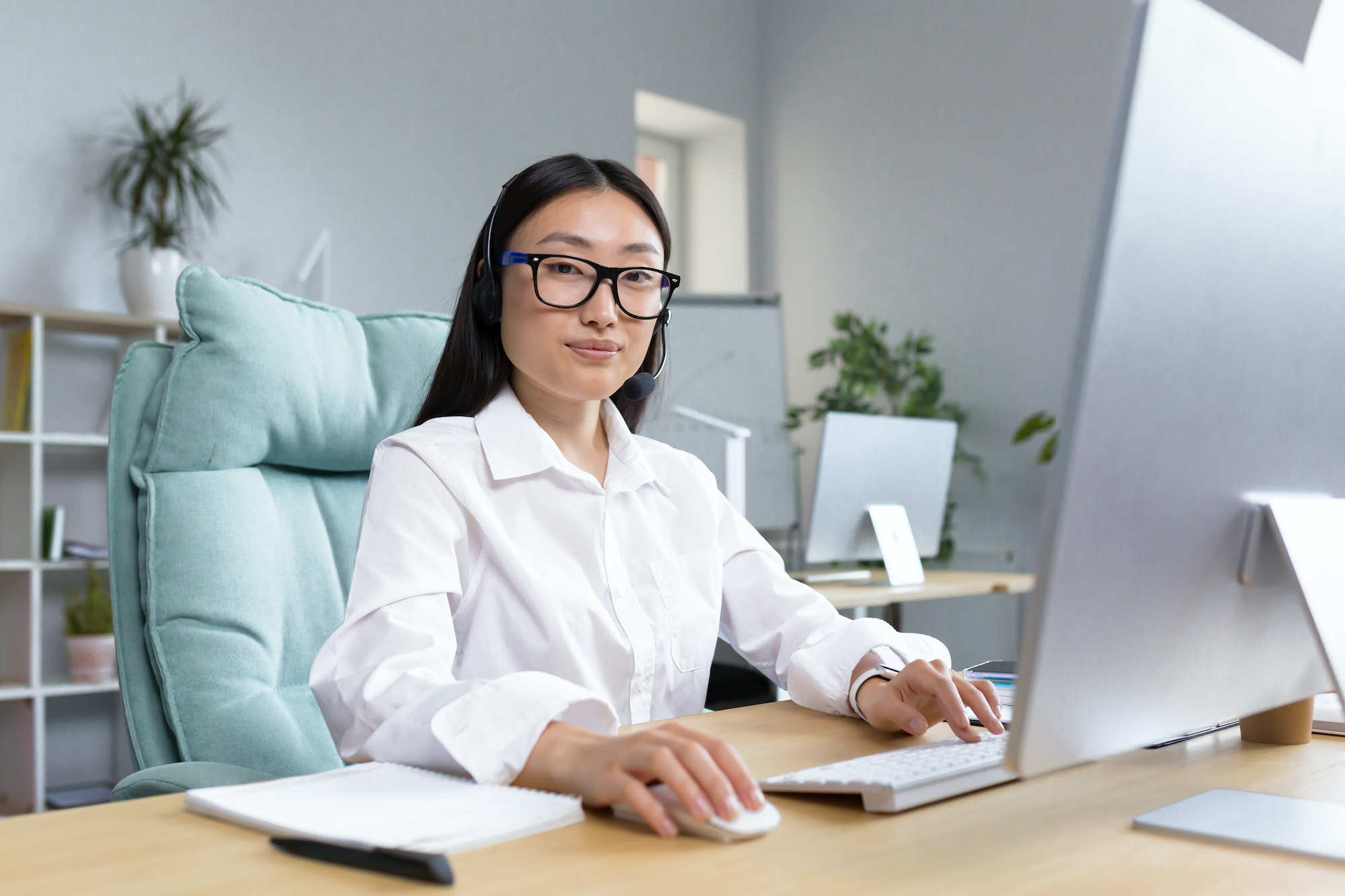 Young tech support worker, portrait Asian business woman working